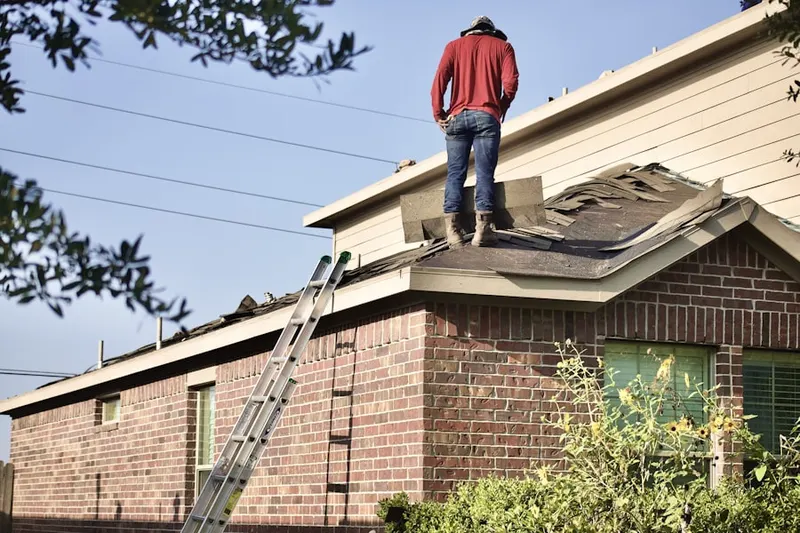 Professional roofer working on a residential roof in North Point